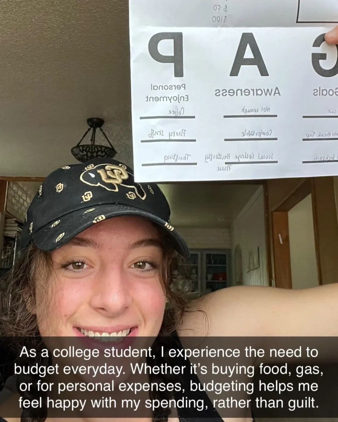 Student proudly displaying financial literacy budget worksheet